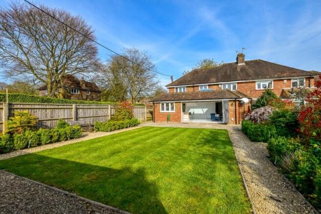 Beautiful family home with brick exterior and well-manicured garden